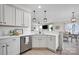 Modern kitchen showcasing white cabinetry, stainless steel appliances, and a convenient breakfast bar area at 704 Fresia Dr, Tega Cay, SC 29708