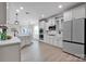 Modern kitchen with white cabinets, stainless steel appliances, and recessed lighting providing a sleek design at 704 Fresia Dr, Tega Cay, SC 29708
