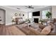 Cozy living room with a fireplace, area rug, ceiling fan and comfortable seating at 704 Fresia Dr, Tega Cay, SC 29708