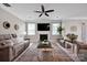 Bright living room with a fireplace, area rug, ceiling fan and comfortable seating at 704 Fresia Dr, Tega Cay, SC 29708