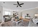 Open living room featuring an area rug, ceiling fan, and seamless access to kitchen at 704 Fresia Dr, Tega Cay, SC 29708