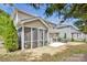 Exterior view of a house featuring a screened porch, backyard, and patio area at 704 Fresia Dr, Tega Cay, SC 29708