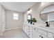 Modern bathroom with dual sinks, white cabinetry and a stylish tile floor at 704 Fresia Dr, Tega Cay, SC 29708