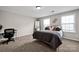Comfortable bedroom featuring plush carpet, ample natural light, and contemporary decor at 704 Fresia Dr, Tega Cay, SC 29708