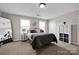 Bright bedroom features carpet floors, natural light from two windows, and an added storage unit at 704 Fresia Dr, Tega Cay, SC 29708