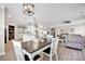 Bright, open-concept dining area featuring modern lighting and seamless flow to the living room and kitchen at 704 Fresia Dr, Tega Cay, SC 29708