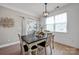 Cozy dining room with a modern chandelier, white shiplap walls, and a dark wood table perfect for Gathering meals at 704 Fresia Dr, Tega Cay, SC 29708