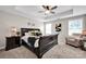 Spacious main bedroom with tray ceiling, ceiling fan, and natural light at 704 Fresia Dr, Tega Cay, SC 29708
