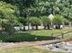Community pool area with mature trees, walking path and black metal fence at 715 21St Ne Ave, Hickory, NC 28601