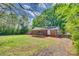 Manicured lawn in a spacious backyard and screened porch with mature trees at 764 Emorywood Ln, Rock Hill, SC 29730