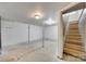 Spacious unfinished basement with painted concrete floors and access to stairs at 764 Emorywood Ln, Rock Hill, SC 29730