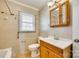 Neutral bathroom featuring a single vanity, window with blinds, and tiled walls at 764 Emorywood Ln, Rock Hill, SC 29730