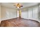 Bedroom featuring wood-look floors, a ceiling fan, closet and access to additional room at 764 Emorywood Ln, Rock Hill, SC 29730