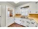 Kitchen features white cabinetry, wood countertops, stainless steel sink, and wooden flooring at 764 Emorywood Ln, Rock Hill, SC 29730
