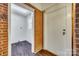 View into a utility room with brick accent wall, wooden flooring and white door at 764 Emorywood Ln, Rock Hill, SC 29730