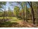 Expansive backyard showcasing lush greenery, mature trees, and a serene, natural landscape at 7790 Caswell Rd, Stanley, NC 28164