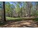 Large, wooded backyard providing privacy and tranquility, backing to a scenic landscape at 7790 Caswell Rd, Stanley, NC 28164