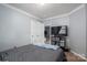 Bedroom featuring large TV, closet and view into another room at 7790 Caswell Rd, Stanley, NC 28164