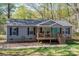 Charming single-story home featuring a cozy front porch and landscaped yard at 7790 Caswell Rd, Stanley, NC 28164
