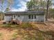 Rear view of a home featuring a small back porch and view of the yard at 7790 Caswell Rd, Stanley, NC 28164