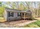 Charming single-story home boasting a front porch and well-manicured landscaping around the property at 7790 Caswell Rd, Stanley, NC 28164