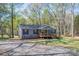 Attractive single-story home with a welcoming porch, nestled among trees and a spacious front yard at 7790 Caswell Rd, Stanley, NC 28164