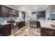 Modern kitchen with stainless steel appliances, dark cabinets, and ample counter space for cooking at 7790 Caswell Rd, Stanley, NC 28164