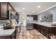 Well-equipped kitchen with stainless steel appliances, dark cabinetry, and an open layout and laundry area at 7790 Caswell Rd, Stanley, NC 28164