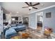 Spacious living room with hardwood floors, comfortable seating, and an open layout to dining and kitchen at 7790 Caswell Rd, Stanley, NC 28164