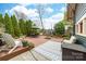 Landscaped backyard with patio seating, firepit, and lush greenery at 803 Catawba St, Belmont, NC 28012