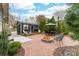 Outdoor living space with fire pit, outdoor dining, and a storage shed at 803 Catawba St, Belmont, NC 28012