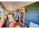 Charming front porch with comfortable seating, decorative lanterns, and a welcoming red door entrance at 803 Catawba St, Belmont, NC 28012