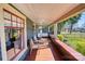 Inviting front porch featuring cozy seating, wood flooring, and pleasant views of the landscaped yard at 803 Catawba St, Belmont, NC 28012
