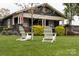 Inviting home with a classic front porch, complemented by lush landscaping and seating at 803 Catawba St, Belmont, NC 28012
