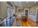 Well-lit kitchen featuring granite countertops, stainless steel sink and butcher block island at 803 Catawba St, Belmont, NC 28012