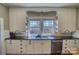 Updated kitchen featuring white cabinets, granite countertops, and stainless steel dishwasher at 803 Catawba St, Belmont, NC 28012