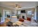 Spacious living room with hardwood floors, fireplace, and open access to the dining area, perfect for entertaining at 803 Catawba St, Belmont, NC 28012