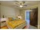 Comfortable main bedroom featuring shiplap accent wall, hardwood floors and barn door at 803 Catawba St, Belmont, NC 28012