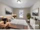 Serene bedroom features neutral decor, plush bedding, natural light, and decorative artwork at 808 Raindrops Rd, Gastonia, NC 28054