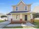Charming two-story home features a welcoming front porch with brick accents and a well-manicured lawn at 808 Raindrops Rd, Gastonia, NC 28054