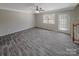 Bright living room featuring stylish wood-look tile flooring and a contemporary ceiling fan at 808 Raindrops Rd, Gastonia, NC 28054