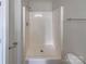 Bathroom featuring a walk-in shower with white surround and brushed nickel fixtures at 808 Raindrops Rd, Gastonia, NC 28054