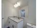 Bathroom vanity with double sinks, granite countertop, and ample lighting with a large mirror at 809 N Ransom St, Gastonia, NC 28052