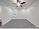 Spacious bedroom featuring neutral walls, plush gray carpet, and a ceiling fan for enhanced comfort at 809 N Ransom St, Gastonia, NC 28052