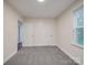 Bedroom with natural light, plush carpeting, and white doors offering convenient access at 809 N Ransom St, Gastonia, NC 28052