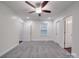 Bright bedroom featuring neutral walls, plush gray carpet, and two entry doors to the room at 809 N Ransom St, Gastonia, NC 28052