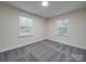Bedroom with gray carpet and two windows providing natural light at 809 N Ransom St, Gastonia, NC 28052