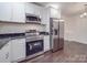 Open kitchen showcases new stainless steel appliances and connects to dining area at 809 N Ransom St, Gastonia, NC 28052