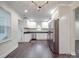 Spacious kitchen and dining room with stainless steel appliances and white cabinets offering a modern and sleek design at 809 N Ransom St, Gastonia, NC 28052