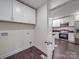 Pass through Laundry area view into kitchen with stainless steel appliances and countertops at 809 N Ransom St, Gastonia, NC 28052